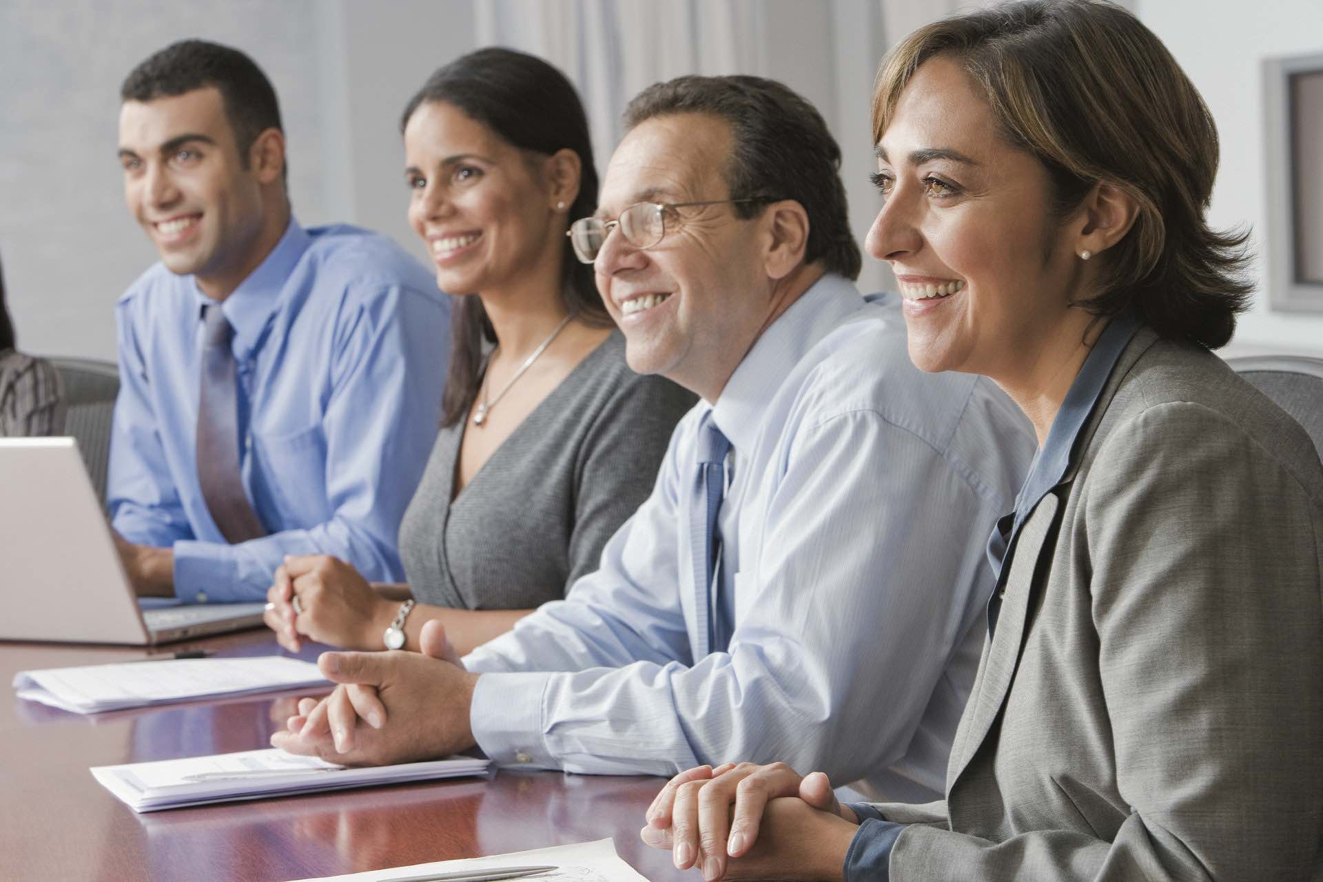 Law meeting-4784910_1920 reduced Group of business people at a conference table smiling with papers and a laptop on the Archangel Law Group website Business Law page