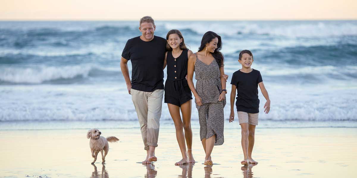 Family walking on the beach with their dog representing family law